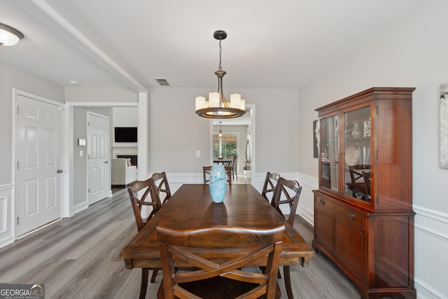 dining space featuring a chandelier and light hardwood / wood-style floors