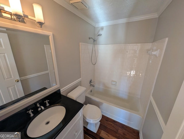 full bathroom featuring toilet, tub / shower combination, a textured ceiling, ornamental molding, and hardwood / wood-style floors