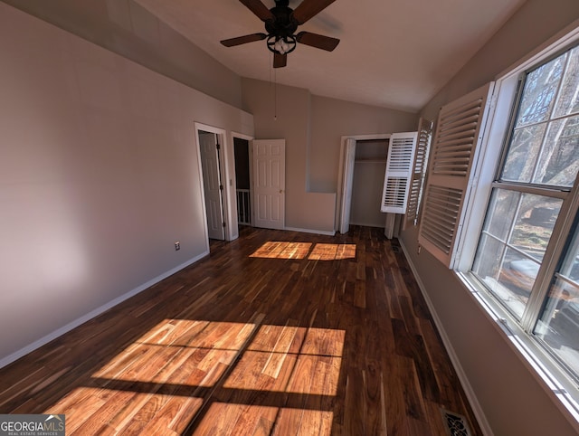 unfurnished bedroom featuring ceiling fan, lofted ceiling, and dark hardwood / wood-style flooring