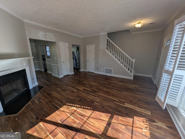 unfurnished living room with crown molding, dark hardwood / wood-style flooring, and a textured ceiling