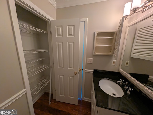 bathroom featuring vanity, crown molding, and wood-type flooring