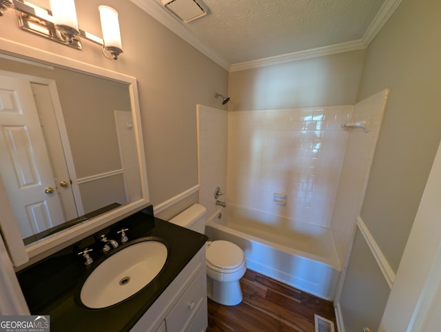 full bathroom with hardwood / wood-style floors, bathtub / shower combination, vanity, crown molding, and a textured ceiling