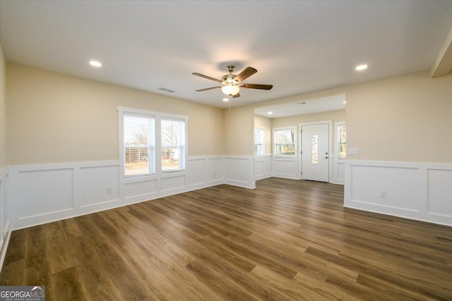 spare room featuring dark wood-type flooring and ceiling fan