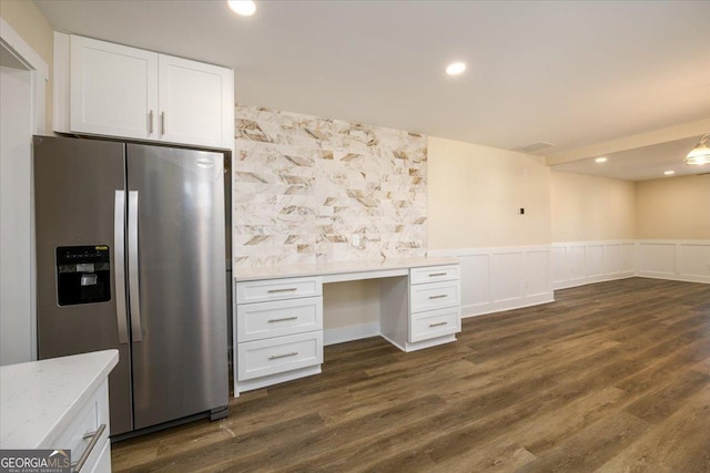 unfurnished office featuring built in desk and dark hardwood / wood-style flooring