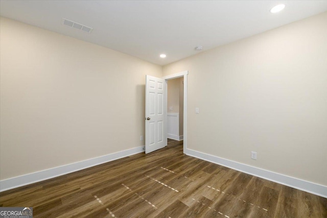 spare room with dark hardwood / wood-style floors