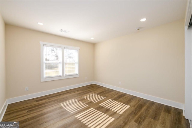 unfurnished room featuring dark wood-type flooring