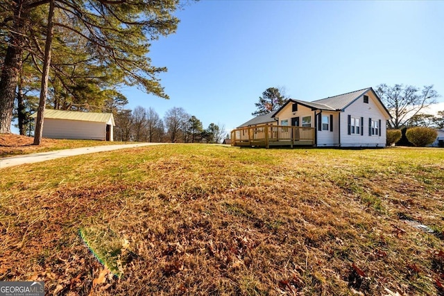 view of side of property featuring a wooden deck and a lawn