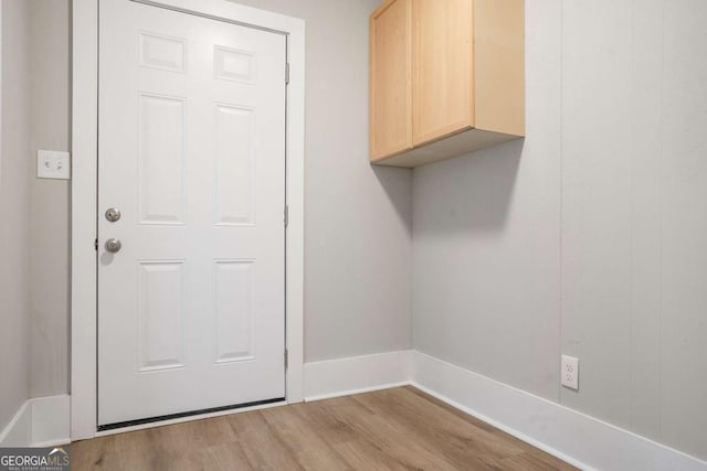 laundry area featuring light wood-type flooring