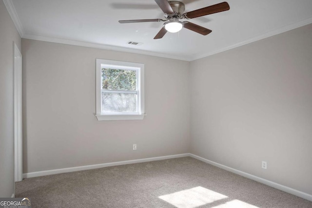 unfurnished room with ceiling fan, ornamental molding, and carpet flooring