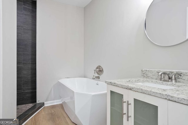 bathroom featuring independent shower and bath, vanity, and hardwood / wood-style floors