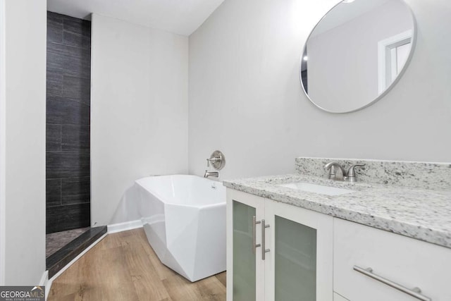 bathroom featuring hardwood / wood-style flooring, vanity, and independent shower and bath