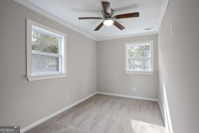 unfurnished room featuring ceiling fan, ornamental molding, and light carpet