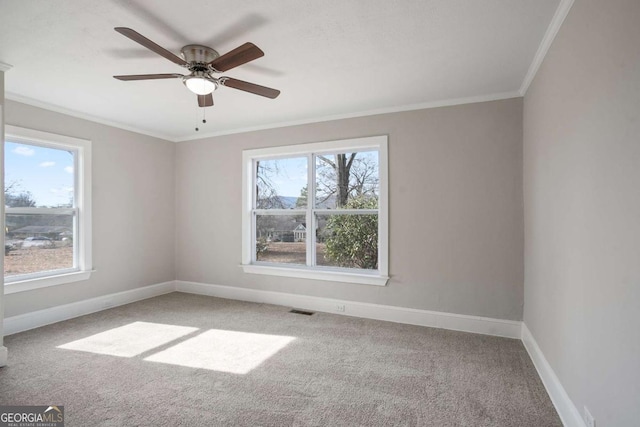 carpeted spare room with ornamental molding and ceiling fan