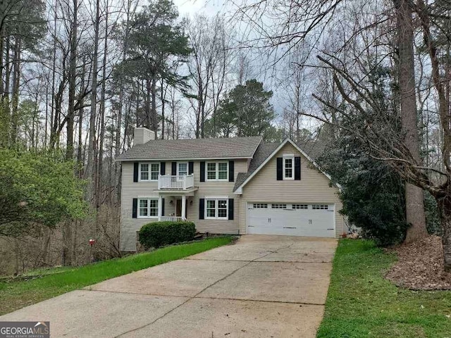 view of front of home with a balcony and a garage