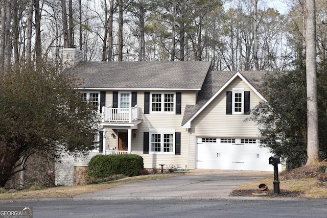 view of front of home with a balcony and a garage