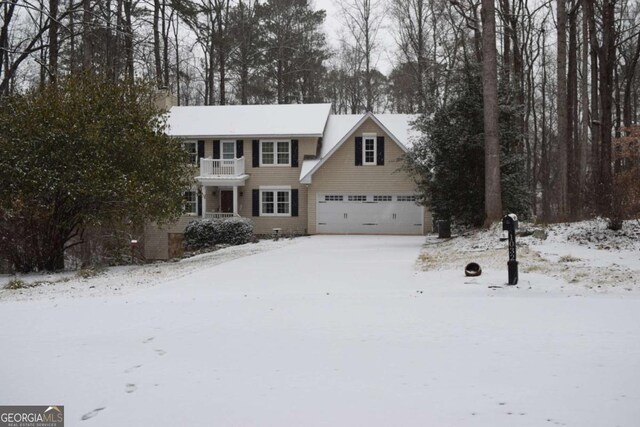 view of front of house with a garage and a balcony