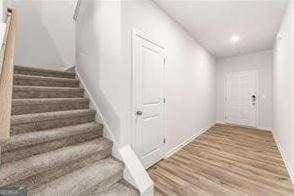 stairway featuring hardwood / wood-style flooring