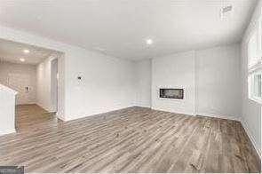 unfurnished living room featuring hardwood / wood-style floors and a fireplace