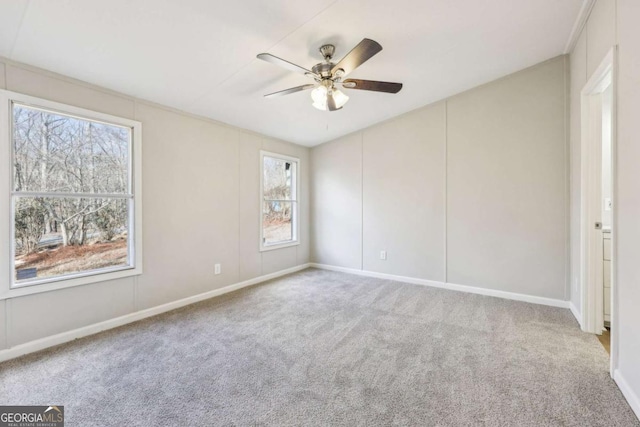 carpeted spare room with ceiling fan