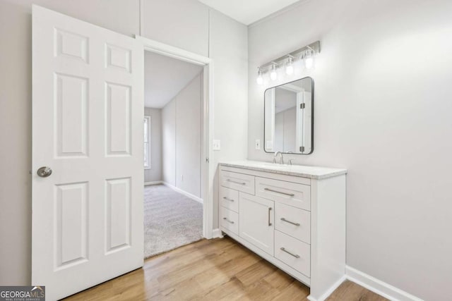 bathroom with hardwood / wood-style flooring and vanity