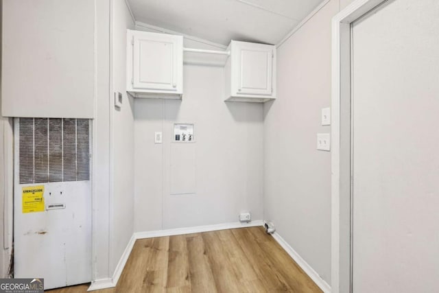 washroom with cabinets, washer hookup, and light hardwood / wood-style floors