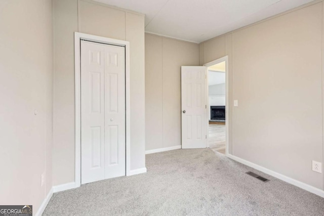 unfurnished bedroom featuring carpet floors and a closet