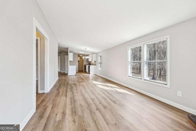 unfurnished living room with lofted ceiling and light hardwood / wood-style flooring