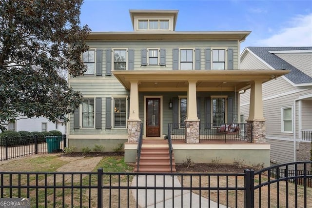 view of front of home with a porch and a fenced front yard