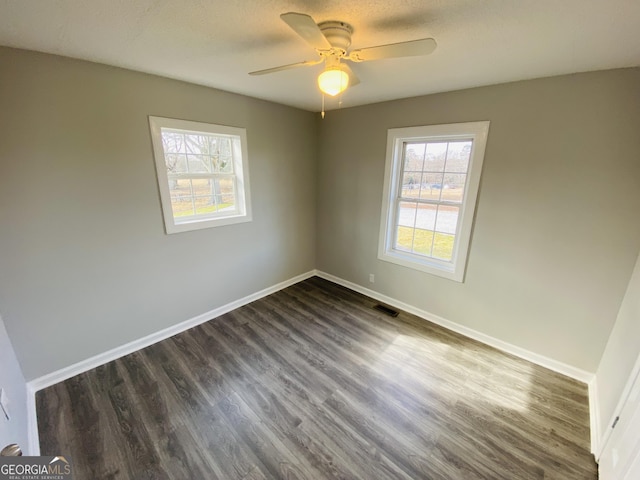 spare room with ceiling fan and dark hardwood / wood-style floors