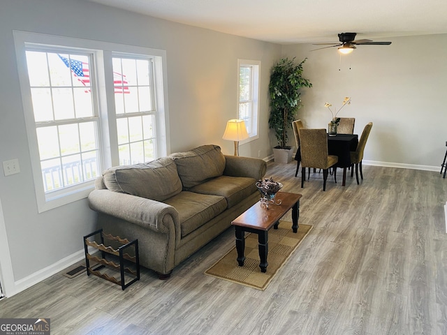 living room featuring ceiling fan and light wood-type flooring