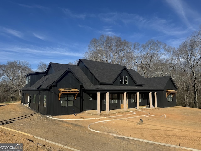 modern inspired farmhouse featuring a shingled roof