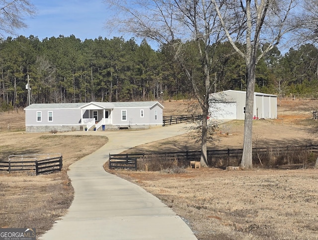 view of front of home featuring a garage and an outdoor structure