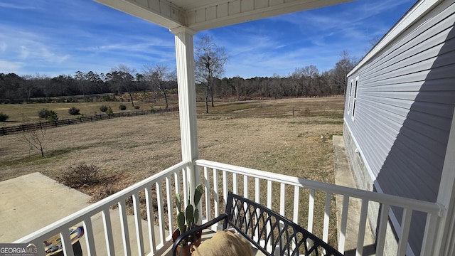 exterior space with a rural view and fence