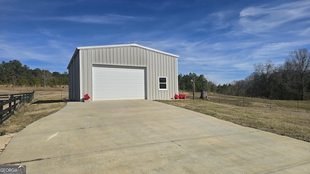 detached garage featuring fence