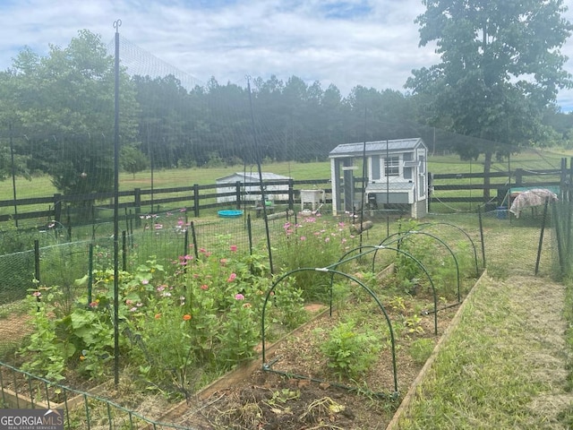 view of yard featuring an outdoor structure and a rural view