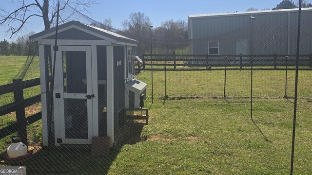 view of front facade featuring fence and a rural view