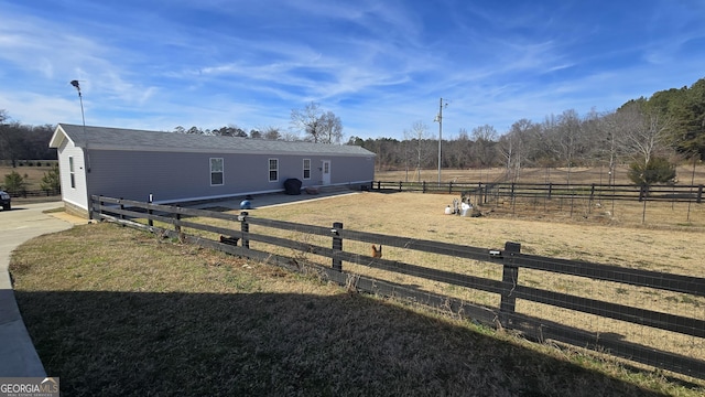 exterior space featuring a lawn and a rural view