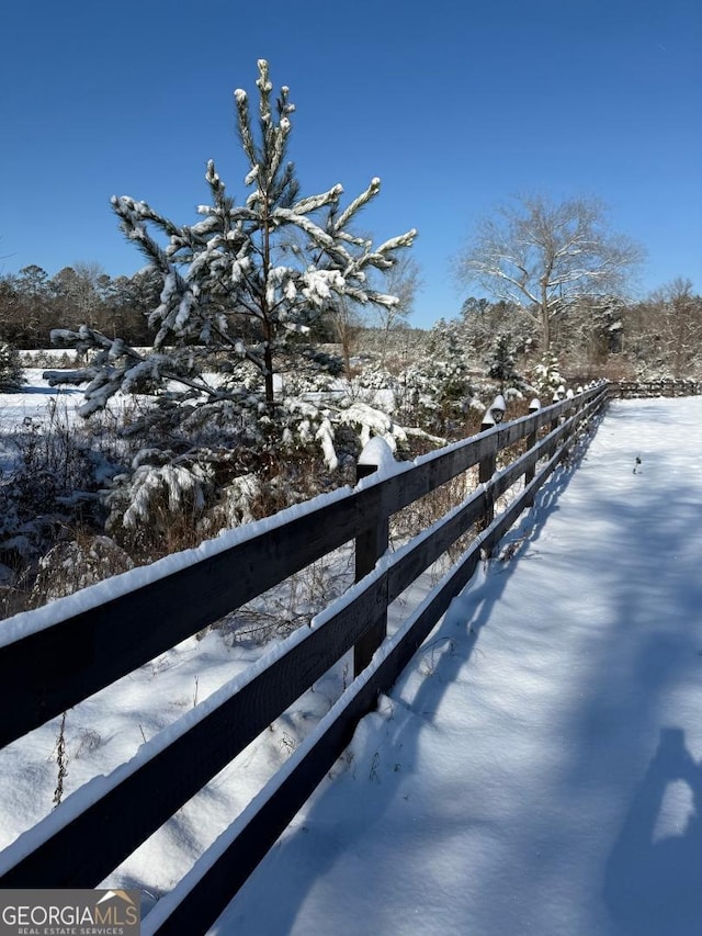 view of snow covered back of property