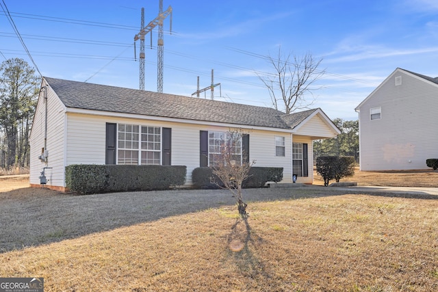 single story home featuring a front lawn