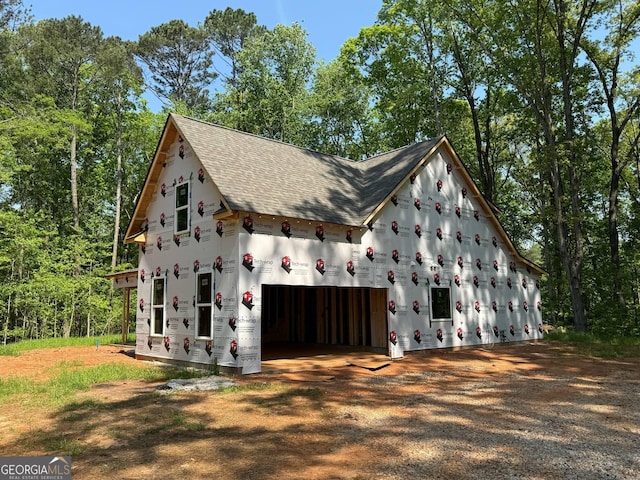 150 Asa Moseley Rd, Mcdonough, GA 30252 - view of side of property featuring a shingled roof, an outdoor structure, driveway, and a garage
