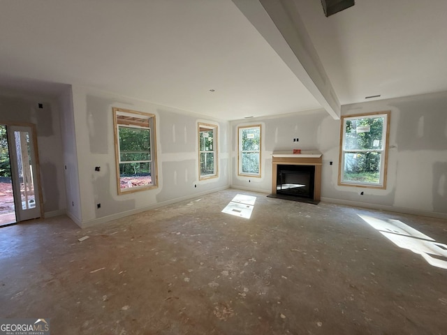 150 Asa Moseley Rd, Mcdonough, GA 30252 - unfurnished living room with healthy amount of natural light, a fireplace with raised hearth, and baseboards