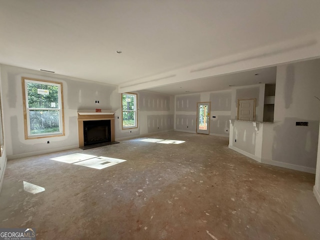 150 Asa Moseley Rd, Mcdonough, GA 30252 - unfurnished living room with a fireplace with flush hearth and baseboards