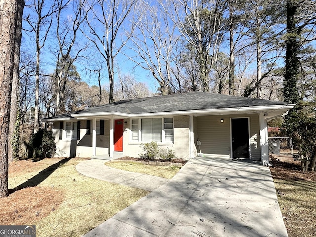 ranch-style house featuring a carport and a front yard