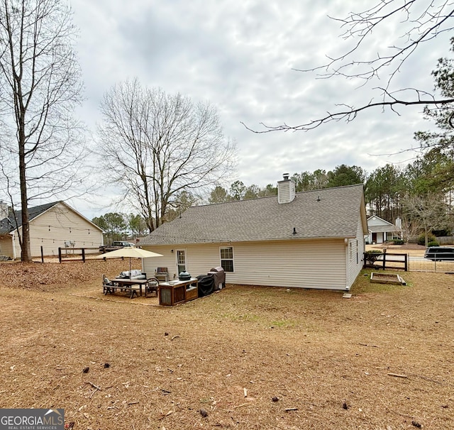 rear view of property with a yard