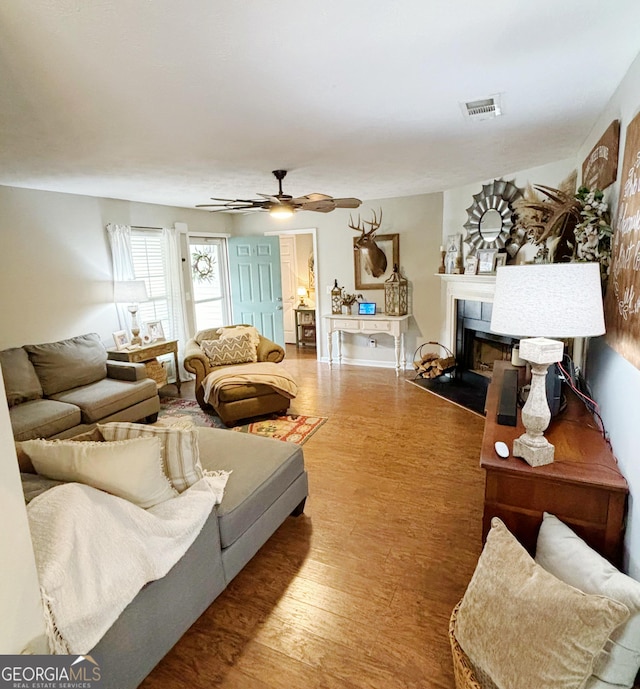 living room with ceiling fan and wood-type flooring