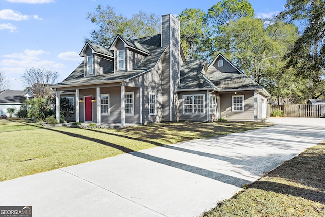 new england style home with a garage and a front yard