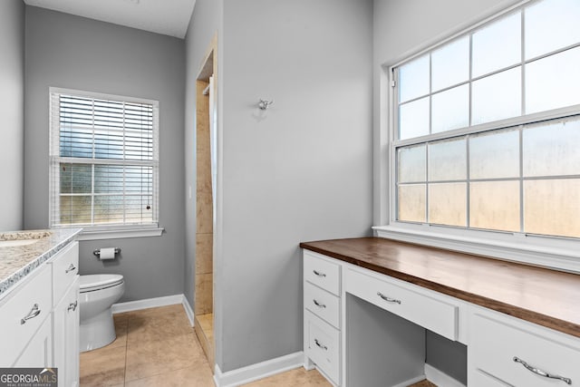 bathroom with vanity, tile patterned floors, and toilet