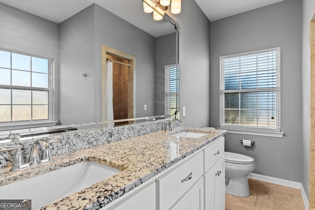 bathroom featuring tile patterned flooring, vanity, and toilet