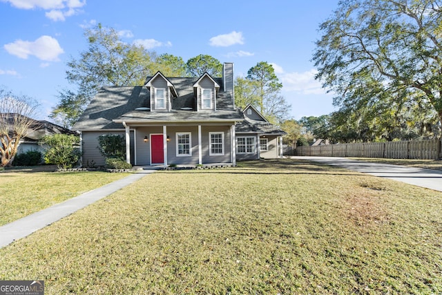 cape cod house with a front yard and covered porch