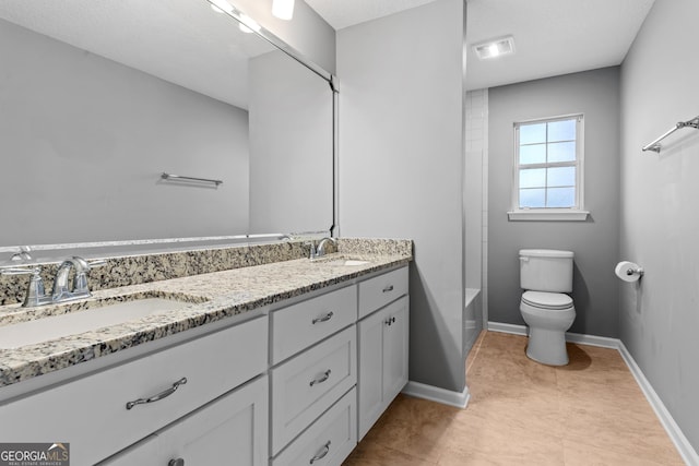 bathroom featuring vanity, toilet, and tile patterned flooring